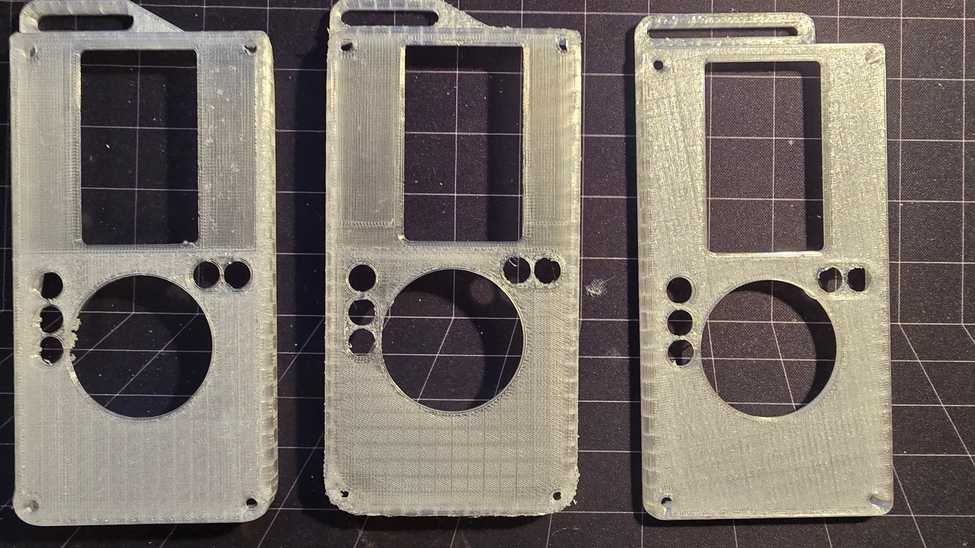 Three clear printed front plates with the screen window, button holes and dial opening